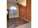 Spacious living room boasts dark wood-look floors, ceiling fan, and natural light at 11233 W Olive Dr, Avondale, AZ 85392