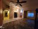 Spacious living room boasts tile floors, a ceiling fan, an archway, and natural light at 11233 W Olive Dr, Avondale, AZ 85392