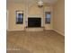 Spacious living room featuring tile flooring, a fireplace, and windows at 11233 W Olive Dr, Avondale, AZ 85392