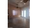 Bright living room area with a ceiling fan and a set of glass patio doors at 11233 W Olive Dr, Avondale, AZ 85392