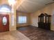 Open living room features a large arched window and dark wood-look floors at 11233 W Olive Dr, Avondale, AZ 85392