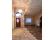 Open living room features a large arched window and dark wood-look floors at 11233 W Olive Dr, Avondale, AZ 85392