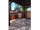 A covered outdoor kitchen area featuring a built in grill perfect for entertaining guests at 11233 W Olive Dr, Avondale, AZ 85392