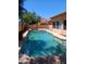 Sparkling private pool in backyard with a mature green landscape providing a relaxing outdoor oasis at 11233 W Olive Dr, Avondale, AZ 85392