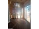 Inviting sunroom featuring polished wood floors, a mini-split AC, and sliding glass door to the outside at 11233 W Olive Dr, Avondale, AZ 85392