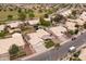 An aerial shot reveals a quiet neighborhood with well-maintained homes, verdant lawns, and palm-lined streets at 1150 E Tyson St, Chandler, AZ 85225