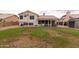 View of a spacious backyard featuring a covered patio, well-maintained lawn, storage shed, and mature landscaping at 1150 E Tyson St, Chandler, AZ 85225