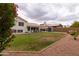 The backyard features a well-maintained lawn, shed, mature trees, and a covered patio, ideal for relaxation at 1150 E Tyson St, Chandler, AZ 85225