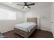 Bedroom with ceiling fan, wood flooring, and a window for natural light at 1150 E Tyson St, Chandler, AZ 85225