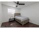 Cozy bedroom features wood-look flooring, a ceiling fan and a queen bed with side tables at 1150 E Tyson St, Chandler, AZ 85225