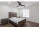 Bedroom features hardwood floors, ceiling fan, window, and a wooden bed frame at 1150 E Tyson St, Chandler, AZ 85225