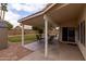 Relaxing covered patio featuring table with chairs and ceiling fan overlooks the spacious backyard at 1150 E Tyson St, Chandler, AZ 85225