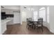 Bright dining area with modern light fixture, wood floors, and large windows at 1150 E Tyson St, Chandler, AZ 85225