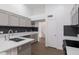 The kitchen has grey cabinets and stainless steel appliances and an island at 1150 E Tyson St, Chandler, AZ 85225