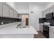 Bright kitchen with grey cabinets, black backsplash, and stainless steel appliances at 1150 E Tyson St, Chandler, AZ 85225