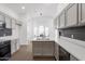 Open kitchen layout with white countertops, gray cabinetry, and stainless steel appliances at 1150 E Tyson St, Chandler, AZ 85225