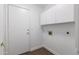 A clean, white laundry room with storage cabinets at 1150 E Tyson St, Chandler, AZ 85225