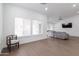 Open living space featuring wood floors, large windows, and a comfortable gray sofa at 1150 E Tyson St, Chandler, AZ 85225