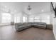 Open-concept living room with modern gray sofa and wood flooring at 1150 E Tyson St, Chandler, AZ 85225