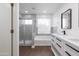 Well-lit primary bathroom features a walk-in shower, soaking tub and modern vanity at 1150 E Tyson St, Chandler, AZ 85225