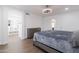 Spacious primary bedroom with modern lighting, wood-look floors, and entrance to the primary bath at 1150 E Tyson St, Chandler, AZ 85225