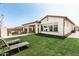 Well-maintained backyard featuring lush green grass and a covered patio for outdoor entertaining and relaxation at 11818 W Luxton Ln, Avondale, AZ 85323