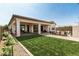 Spacious backyard with an inviting covered patio, perfect for outdoor gatherings and leisure activities at 11818 W Luxton Ln, Avondale, AZ 85323