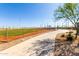 Community baseball field with a walking path, trees and playground at 11818 W Luxton Ln, Avondale, AZ 85323