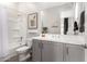 Nicely appointed bathroom with a gray vanity and a shower and tub combination at 11818 W Luxton Ln, Avondale, AZ 85323