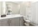 Well lit bathroom featuring a shower/tub combination and a gray vanity with a large mirror at 11818 W Luxton Ln, Avondale, AZ 85323