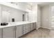 Bathroom with double vanity, gray cabinets, and tile flooring at 11818 W Luxton Ln, Avondale, AZ 85323
