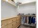 Cozy closet featuring a wooden dresser, shelving, and hanging racks at 11818 W Luxton Ln, Avondale, AZ 85323