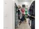 Walk-in closet features ample shelving and hanging storage for clothes and accessories at 11818 W Luxton Ln, Avondale, AZ 85323
