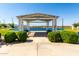 Scenic community lake with a shaded gazebo and benches for relaxing at 11818 W Luxton Ln, Avondale, AZ 85323