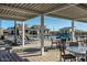 View of the community pool area with covered seating, lounge chairs, and well-maintained facilities for residents at 11818 W Luxton Ln, Avondale, AZ 85323