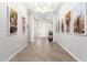 The light-filled entryway features tile floors, neutral walls, and decorative artwork at 11818 W Luxton Ln, Avondale, AZ 85323