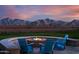Outdoor fire pit with Adirondack chairs for gathering and mountain views at 11818 W Luxton Ln, Avondale, AZ 85323