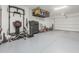 Spacious garage with epoxy floors, storage solutions, and workout equipment at 11818 W Luxton Ln, Avondale, AZ 85323