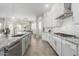 Bright kitchen features white cabinets, granite counters, stainless steel appliances, and breakfast bar at 11818 W Luxton Ln, Avondale, AZ 85323