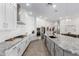 Bright kitchen features white cabinets, granite counters, a large island, and stainless steel appliances at 11818 W Luxton Ln, Avondale, AZ 85323