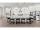 Bright kitchen features white cabinets, granite counters, a large island, and stainless steel appliances at 11818 W Luxton Ln, Avondale, AZ 85323