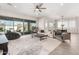 Large open-concept living room with backyard access, leading to a dining room at 11818 W Luxton Ln, Avondale, AZ 85323