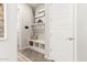 Bright mud room with a bench, storage cubbies, and stylish decor at 11818 W Luxton Ln, Avondale, AZ 85323