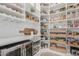 Organized walk-in pantry features ample shelving, drawers, and a wine fridge for ultimate storage at 11818 W Luxton Ln, Avondale, AZ 85323