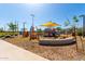 A vibrant community playground with colorful equipment and a shaded play area at 11818 W Luxton Ln, Avondale, AZ 85323