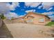 Gravel backyard offers low maintenance landscaping providing views of the home's exterior at 12371 W Hadley St, Avondale, AZ 85323
