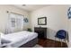 Comfortable bedroom with a window, a bedside table with drawers, and stylish wall decor at 12371 W Hadley St, Avondale, AZ 85323