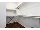 Walk-in closet with wood floors, white walls, and adjustable shelving at 12371 W Hadley St, Avondale, AZ 85323