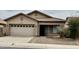 Charming single-story home with a well-maintained front yard, two-car garage, and desert landscaping at 12371 W Hadley St, Avondale, AZ 85323