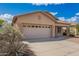 Single-Gathering home featuring a neutral-colored exterior, a two-car garage, and low maintenance landscaping at 12371 W Hadley St, Avondale, AZ 85323